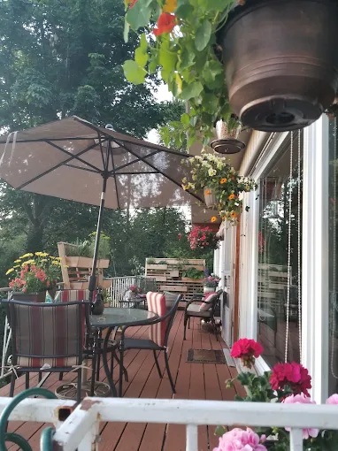 Outdoor patio deck with seating and flowers at Gracious Living